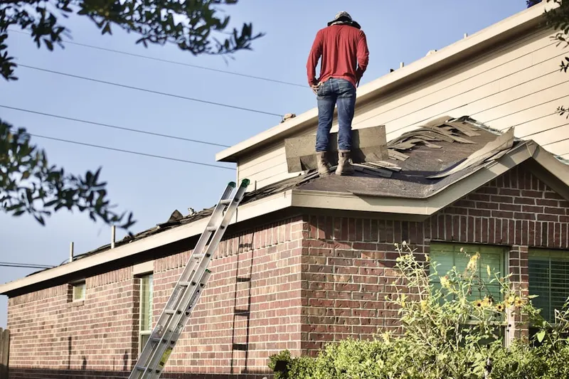 Professional roofer working on a residential roof in Reeds Crossroads